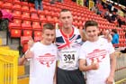 Richard Kilty (Gateshead) with two youngsters at the Gateshead Tartan Games Open.